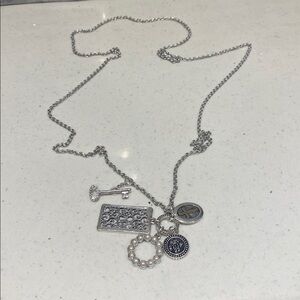 Silver Key and 5 Pendant Attached To Necklace
